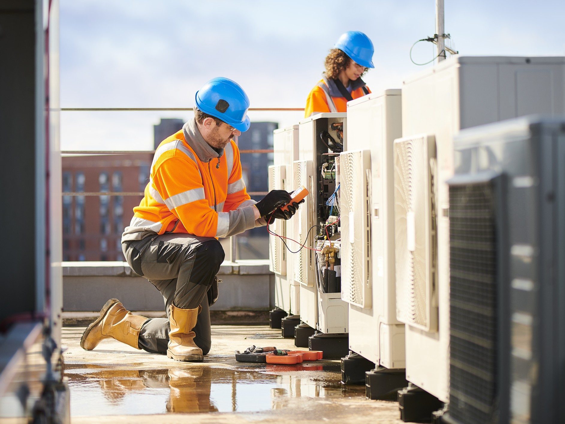 Engineers inspecting industrial air conditioning systems